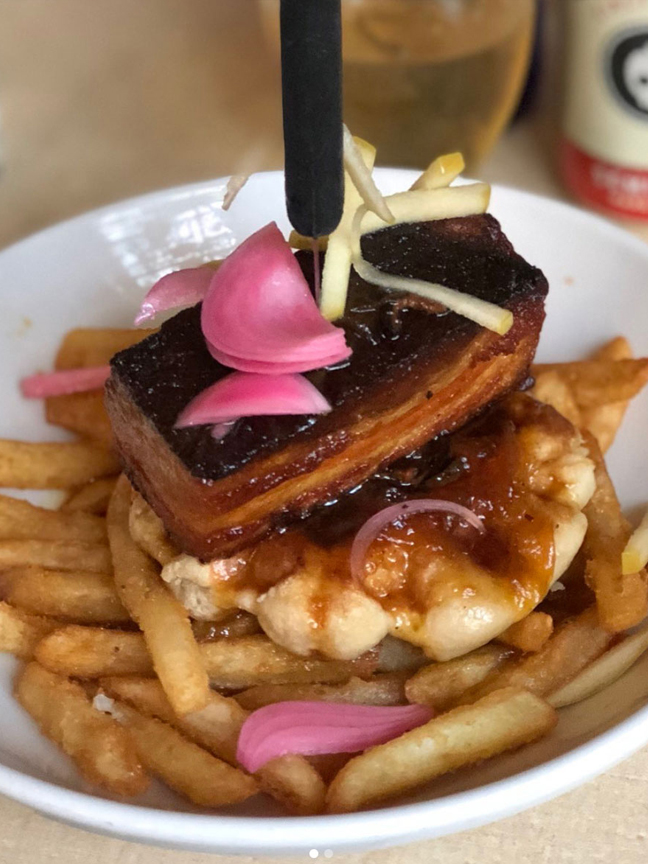  Chef Kayla’s Pork Belly Waffles over fries with pickled onions at Arnold’s Bar & Grill
