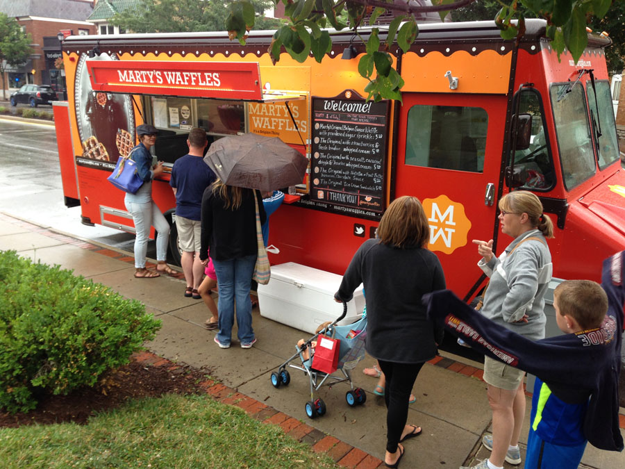 A leisurely crowd gathers at Marty’s Waffles truck in spring time