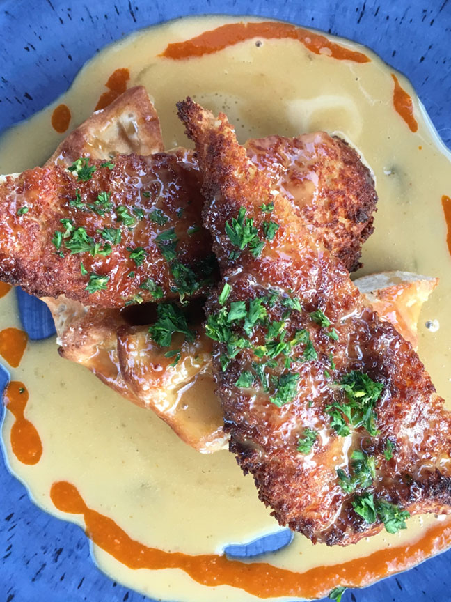 Chef Dave Cervelo’s pickle-juice-brined, crispy fried chicken breast with one of Marty’s Waffles, finished with a chipotle maple beurre blanc and housemade denzel hot sauce